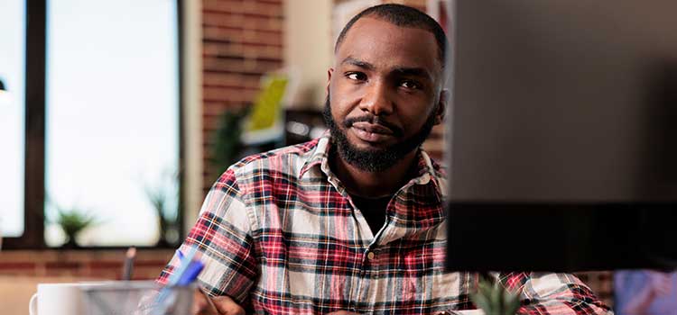 male student studies in self paced cyber security bootcamp